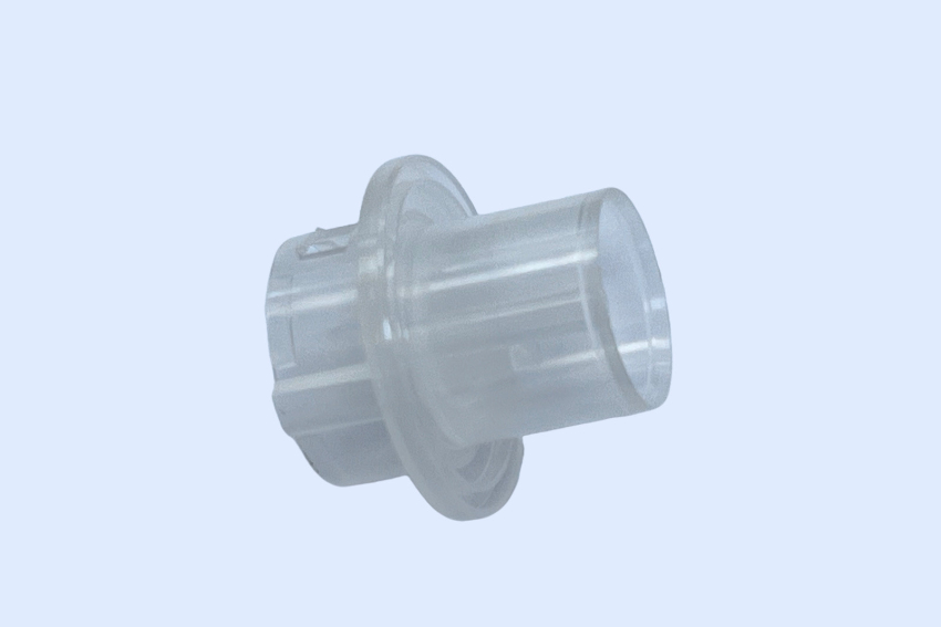 Transparent injection molded plastic connector component with a flanged collar and molded retention features, photographed on a plain light background