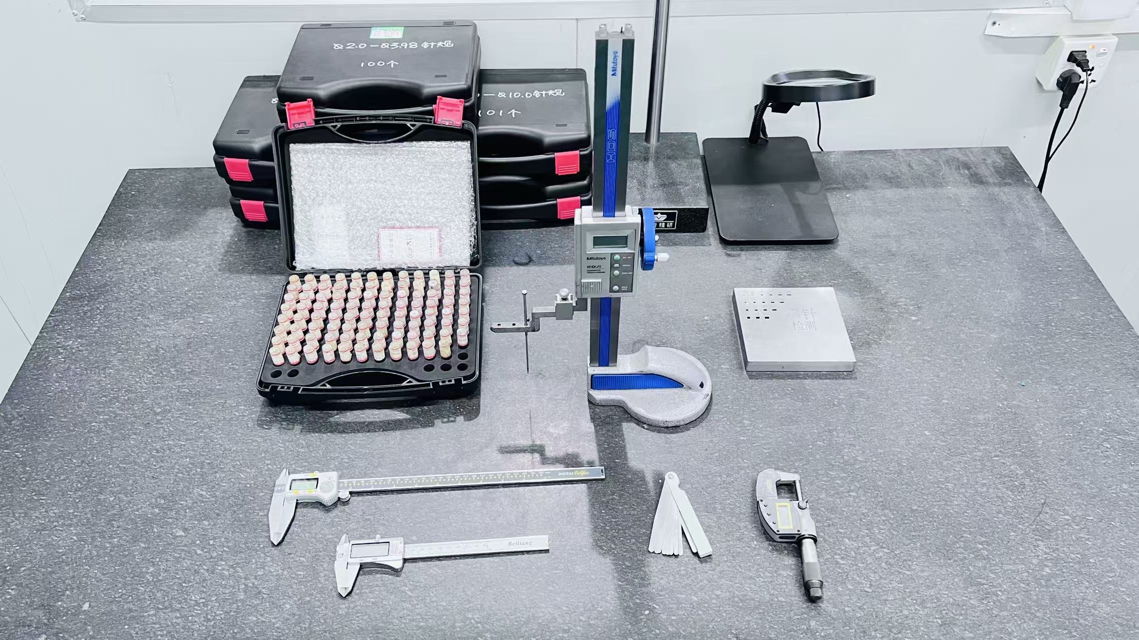 Precision measurement instruments — micrometer, pin gauges, digital height gauge — used for injection molded part inspection at JBRplas Shenzhen